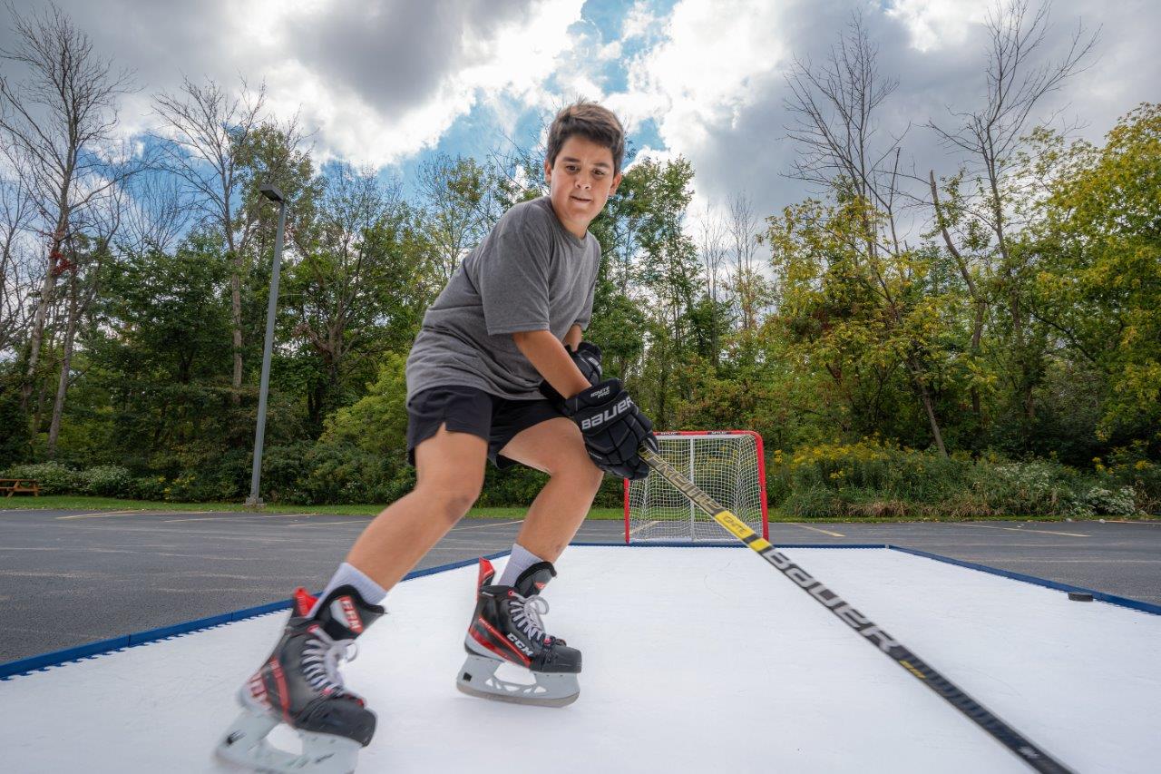 Hockey player excelling in an intense workout on Skate Anytime Synthetic Ice, achieving remarkable results.