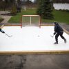 Hockey players improving skills on synthetic ice for backyard training